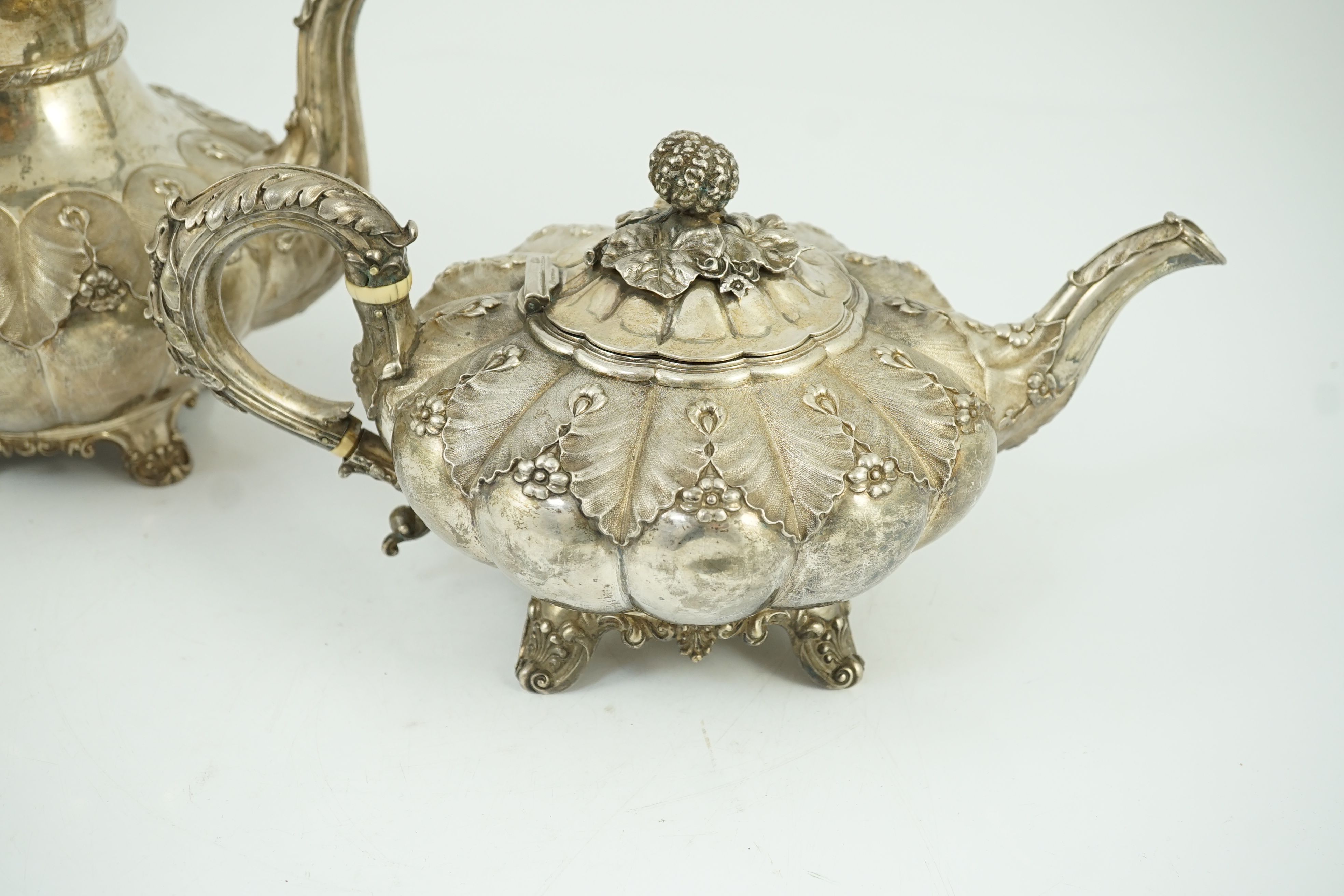 A George IV silver melon shaped coffee pot and matching tea pot by The Barnards